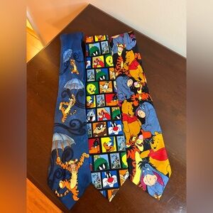 Three whimsical ties, two are Pooh and one is looney tunes